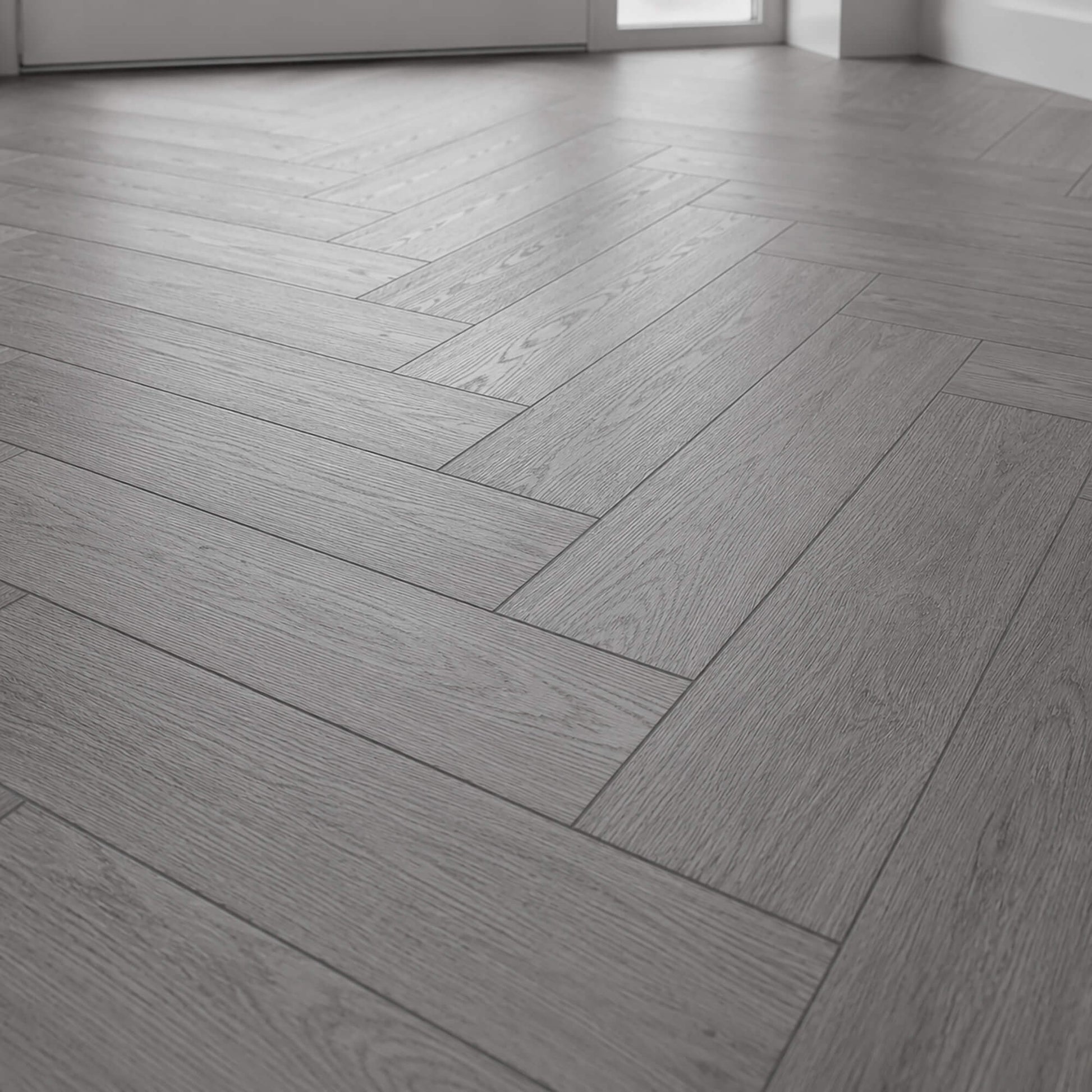 Close-up of Alsace Oak Rigid LVT Herringbone flooring in a home hallway.