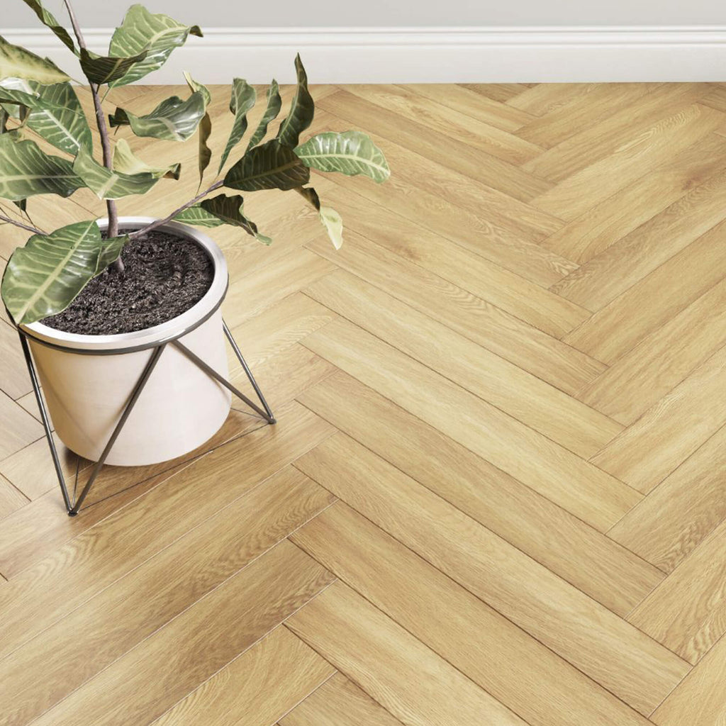 Close-up of Ashford Oak Herringbone Laminate Flooring with a flower pot 