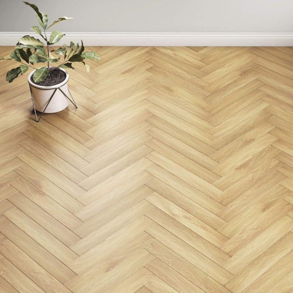 Ashford Oak Herringbone Laminate Flooring in a living room setting with a flower pot in the background.
