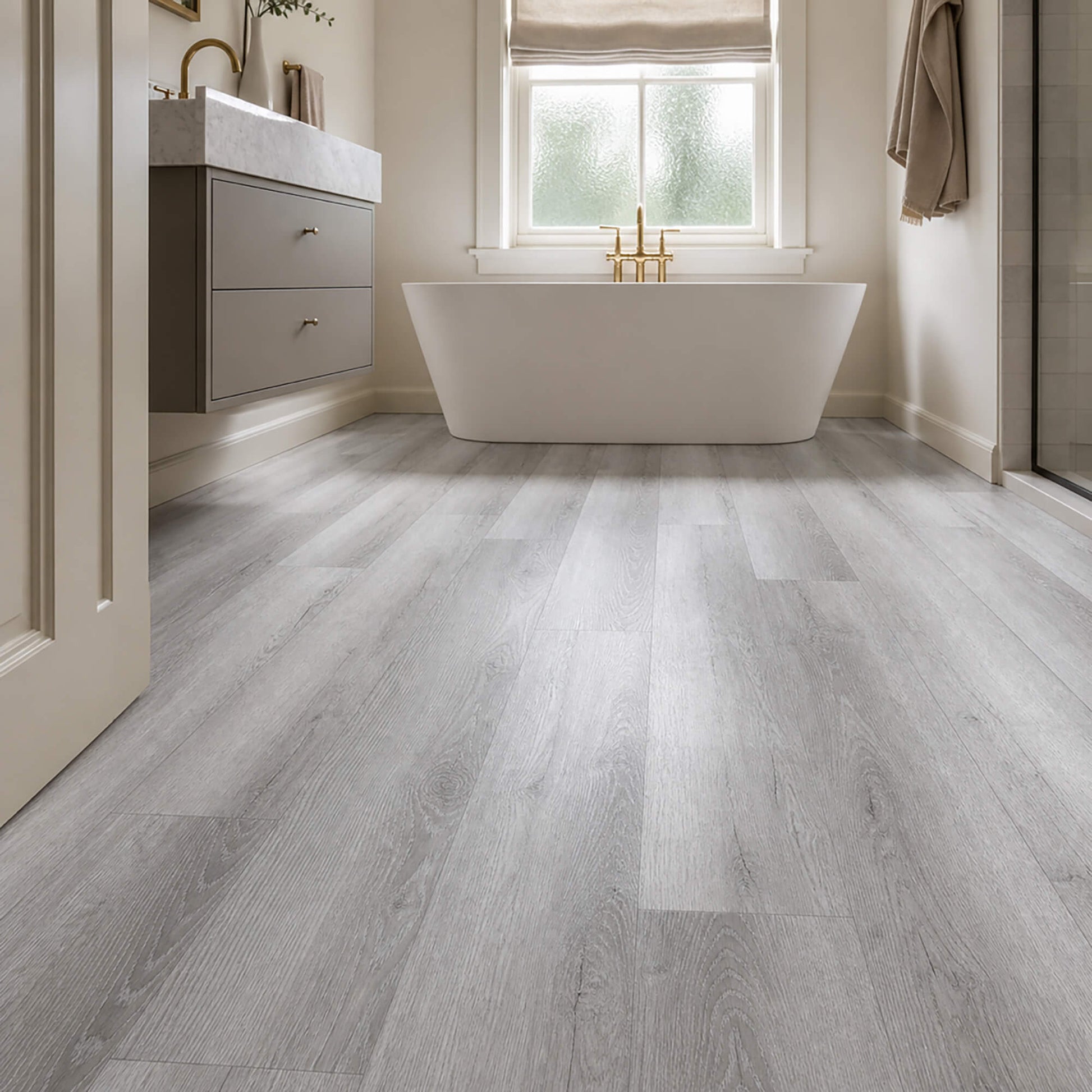 Bamburgh Grey rigid LVT plank flooring in a luxurious home bathroom setting.