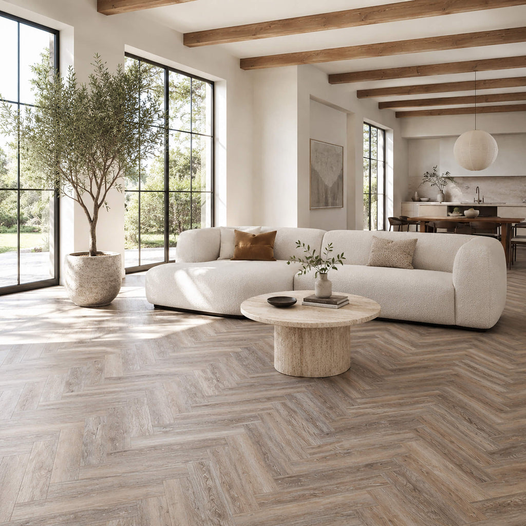 Driftwood Oak Rigid LVT Herringbone flooring in a living room setting.