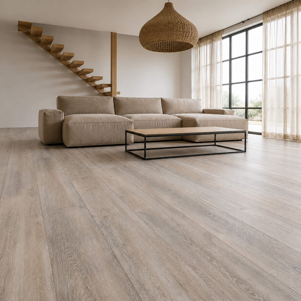 Modern living room with a sectional sofa, coffee table, and Driftwood Oak Rigid LVT wooden floor.