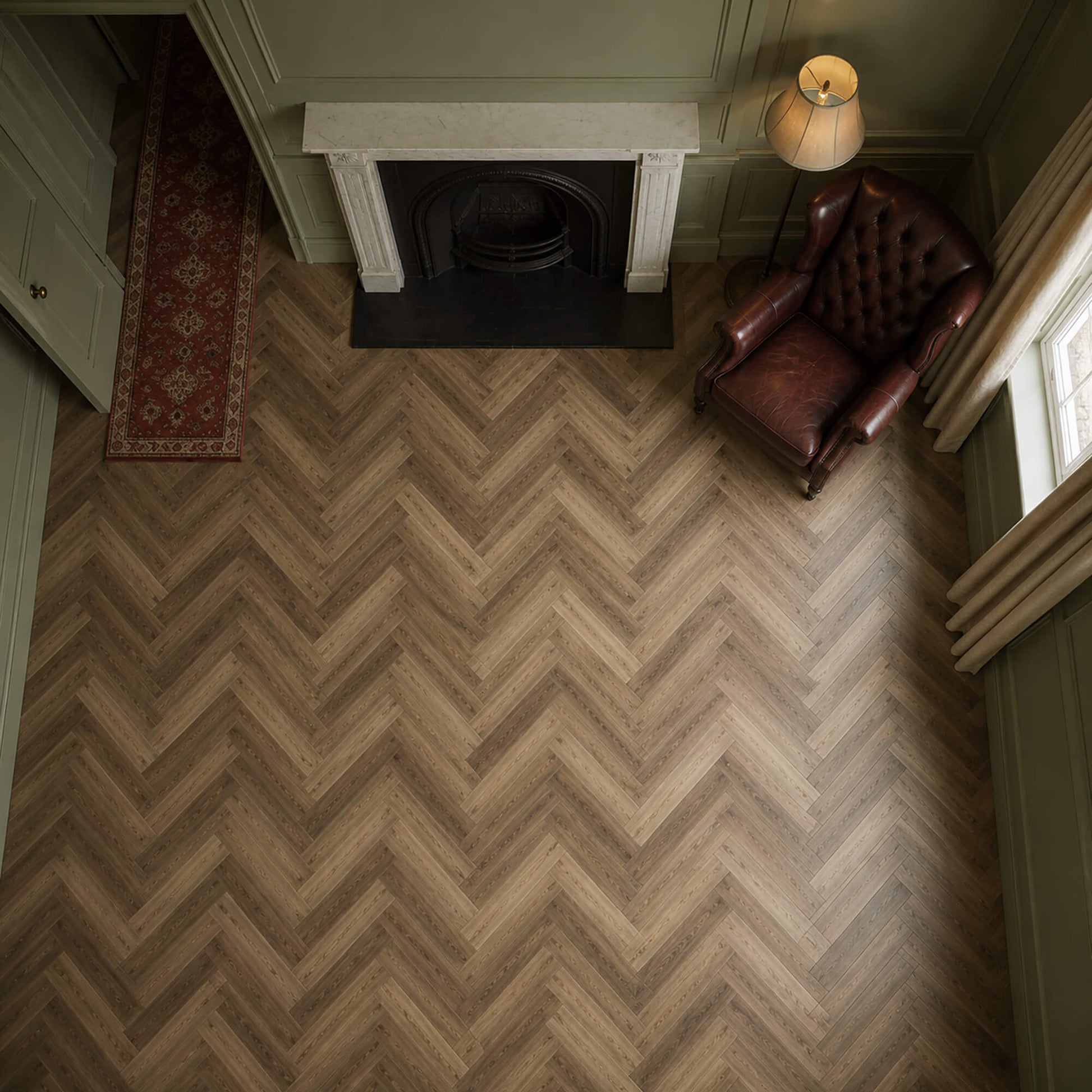 Elevated view of a victorian living room with Fumed Oak LVT herringbone flooring.