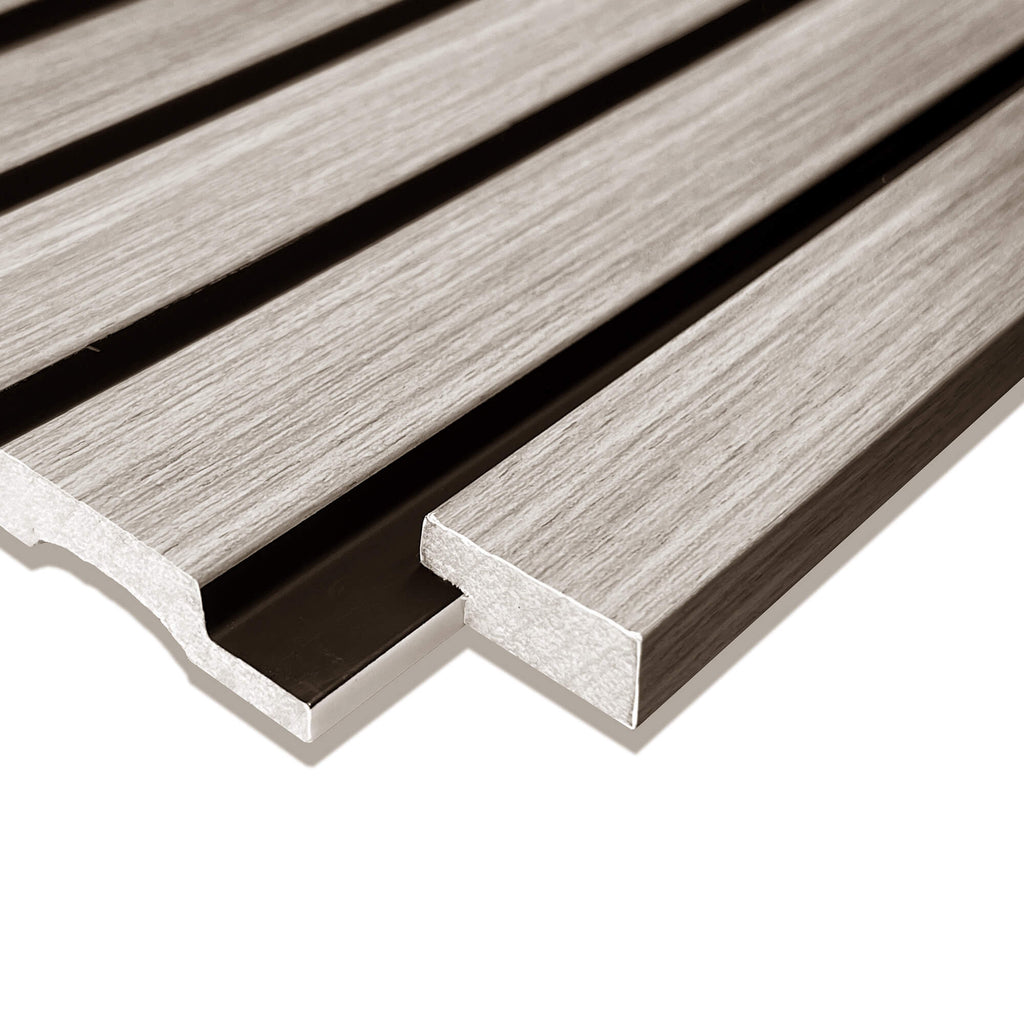 Close-up of a Grey Aqua Slatwall Left Trim being positioned in place on a white background.