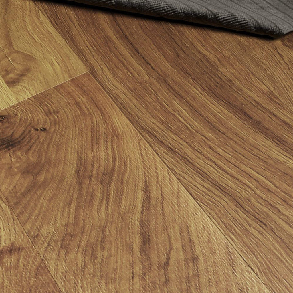 Close-up of Groovy Oak Prestige Laminate Flooring with a rug in the background.