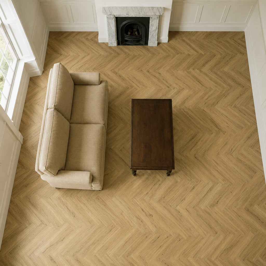 Elevated view of a Heritage Oak Rigid LVT Herringbone floor in a living room setting.