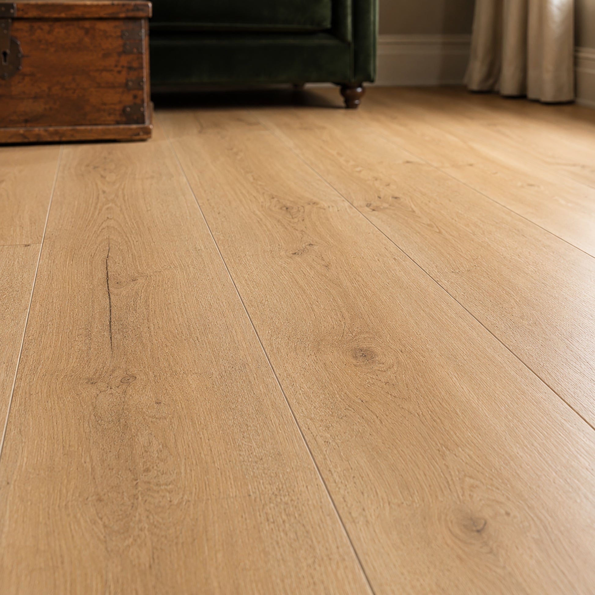 Close-up of a Heritage Oak Rigid LVT floor with a piece of furniture in the background.