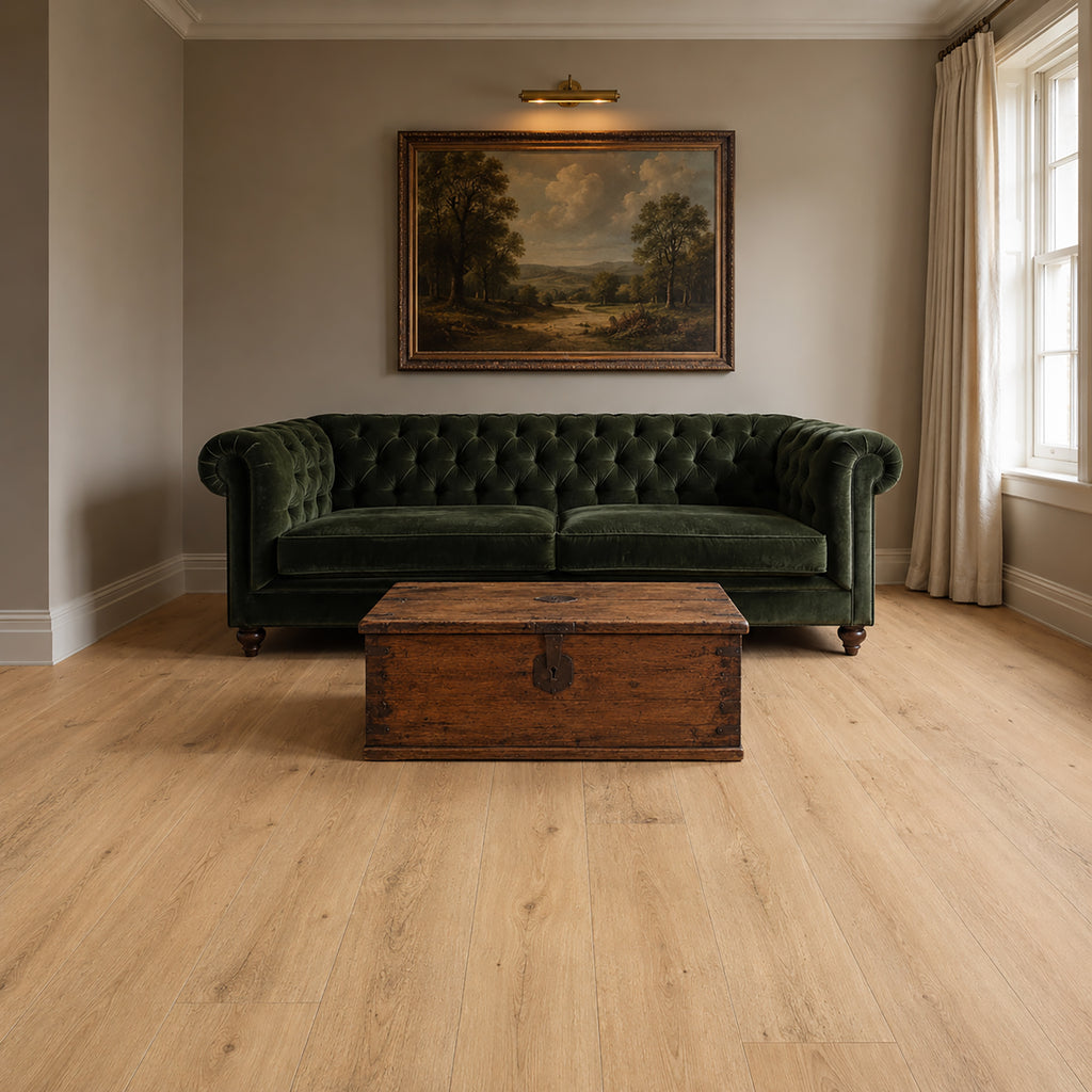 Green velvet sofa in a living room with a Heritage Oak Rigid LVT floor and a painting on the wall.