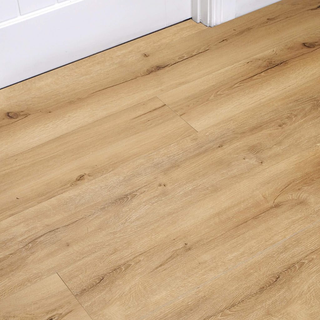Heritage Oak Rigid LVT Flooring with a white door and architrave