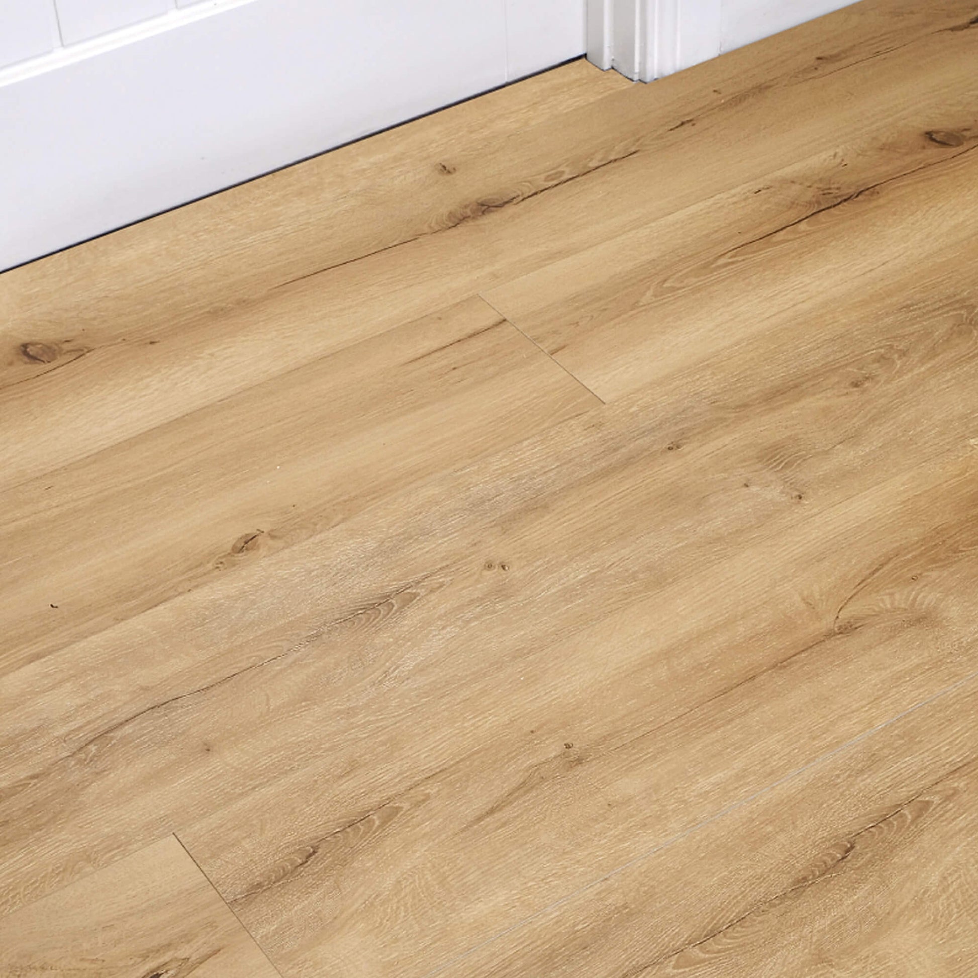 Heritage Oak Rigid LVT Flooring with a white door and architrave