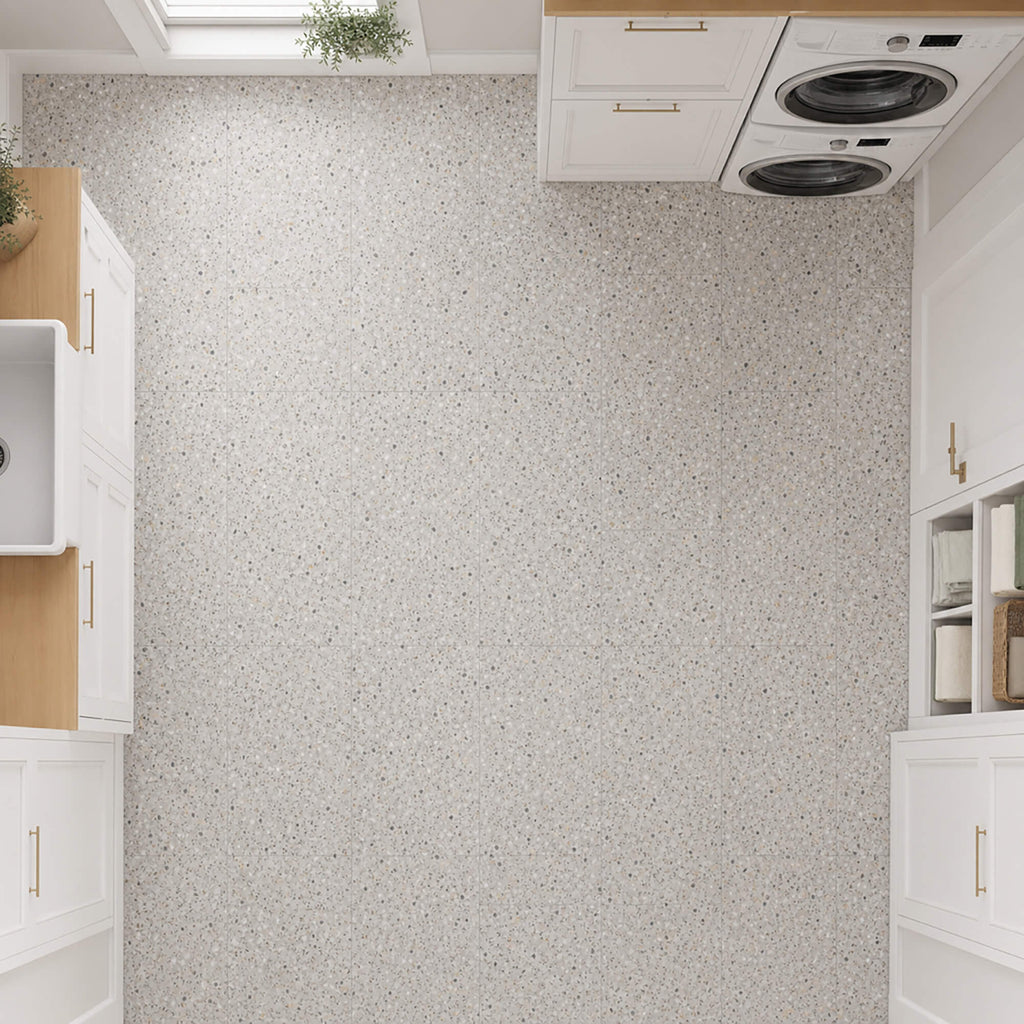 Elevated view of Close-up of Milano Terrazzo Rigid LVT floor tiles in a utility room setting.