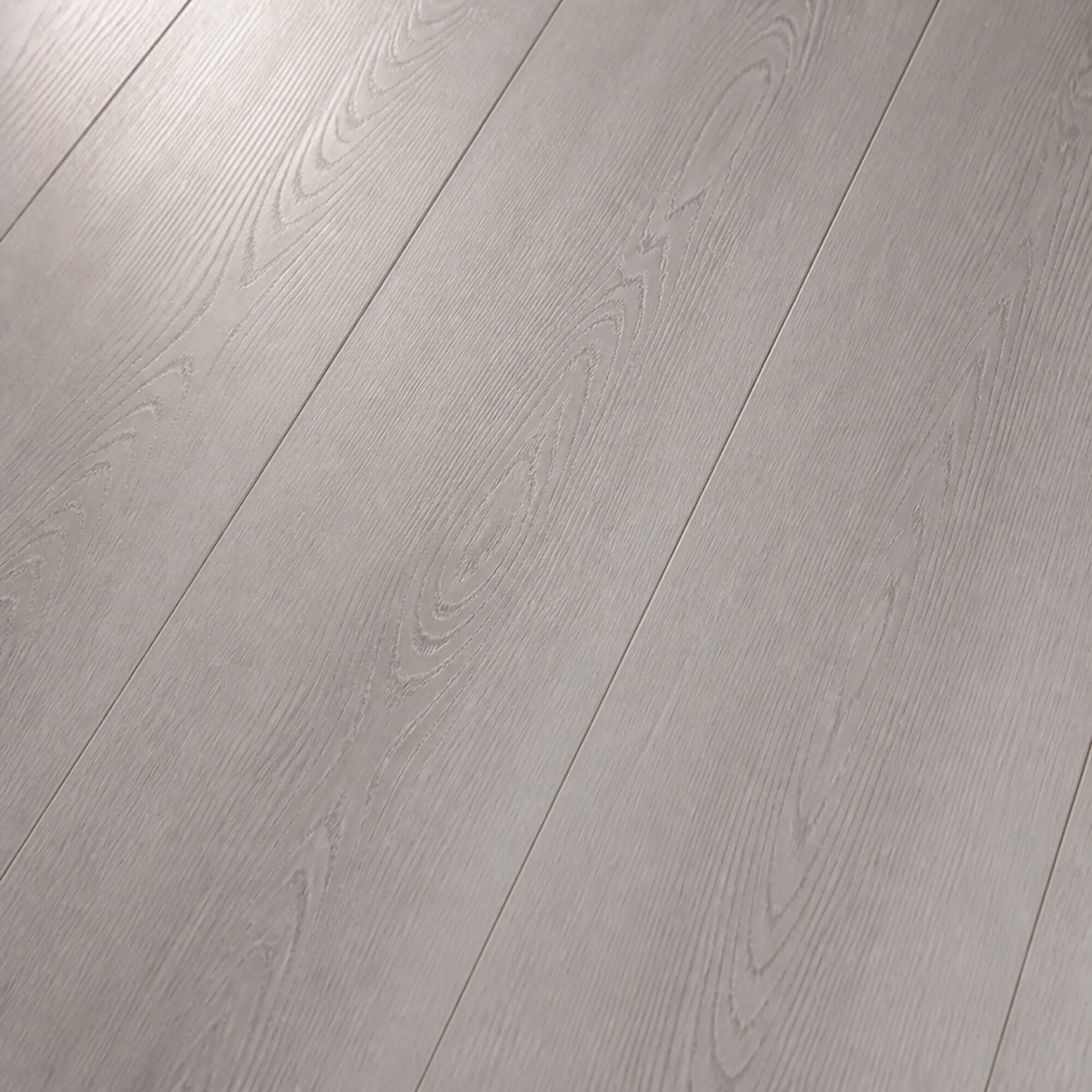 Close-up showing the grain and texture of Misty Grey Prestige Plus laminate flooring.