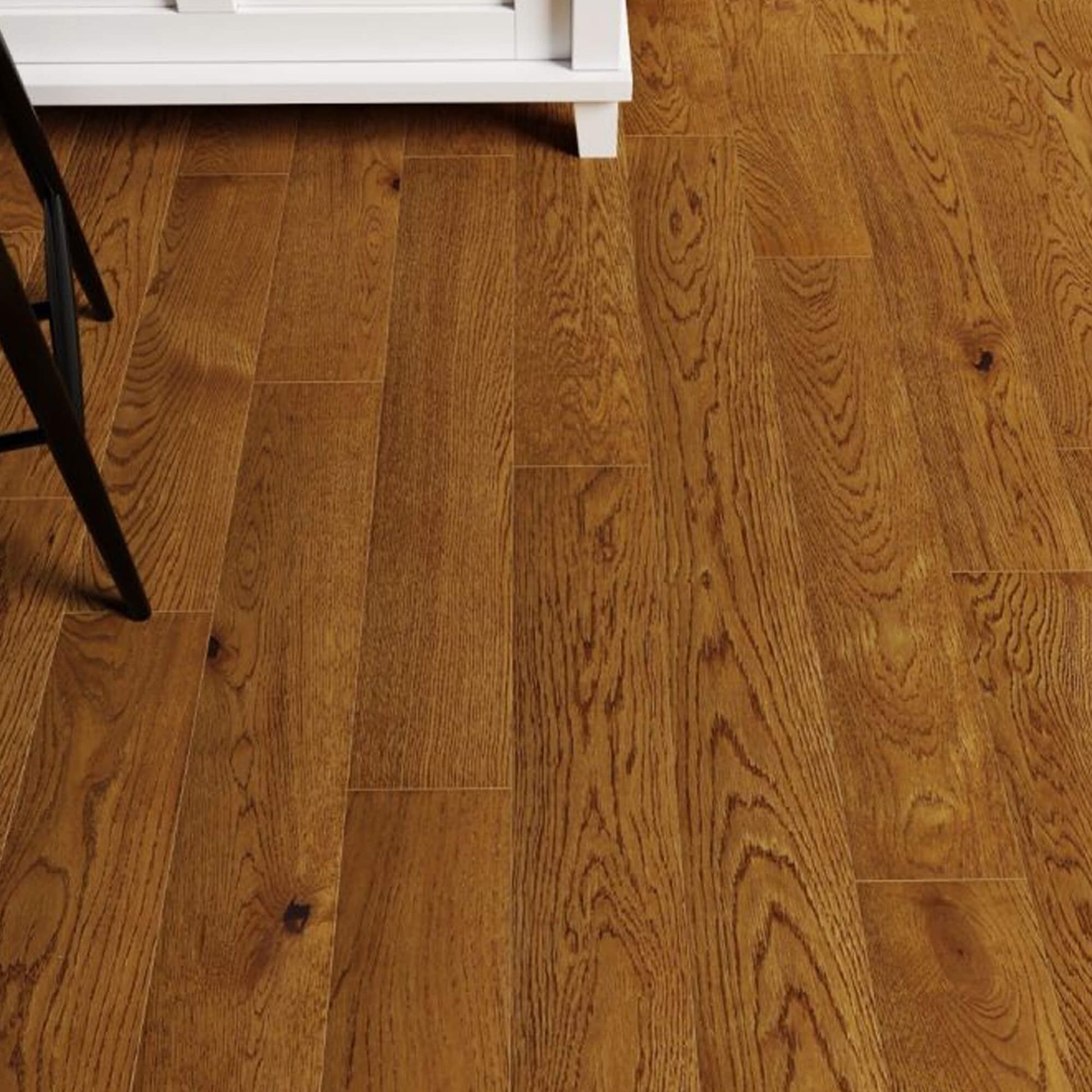 Nutmeg Oak UV Oiled Engineered Wood Flooring with a chair partially visible on the left side.