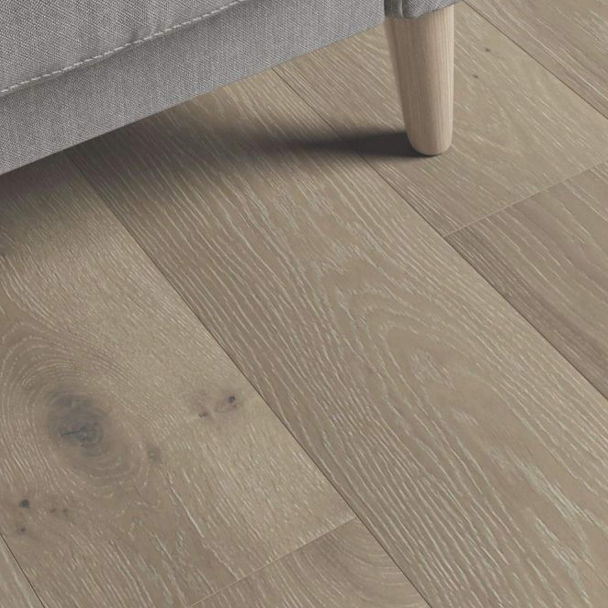 Close-up of Potters Grey Oak Matt Lacquered 190mm Engineered Wood Flooring with a piece of furniture partially visible.