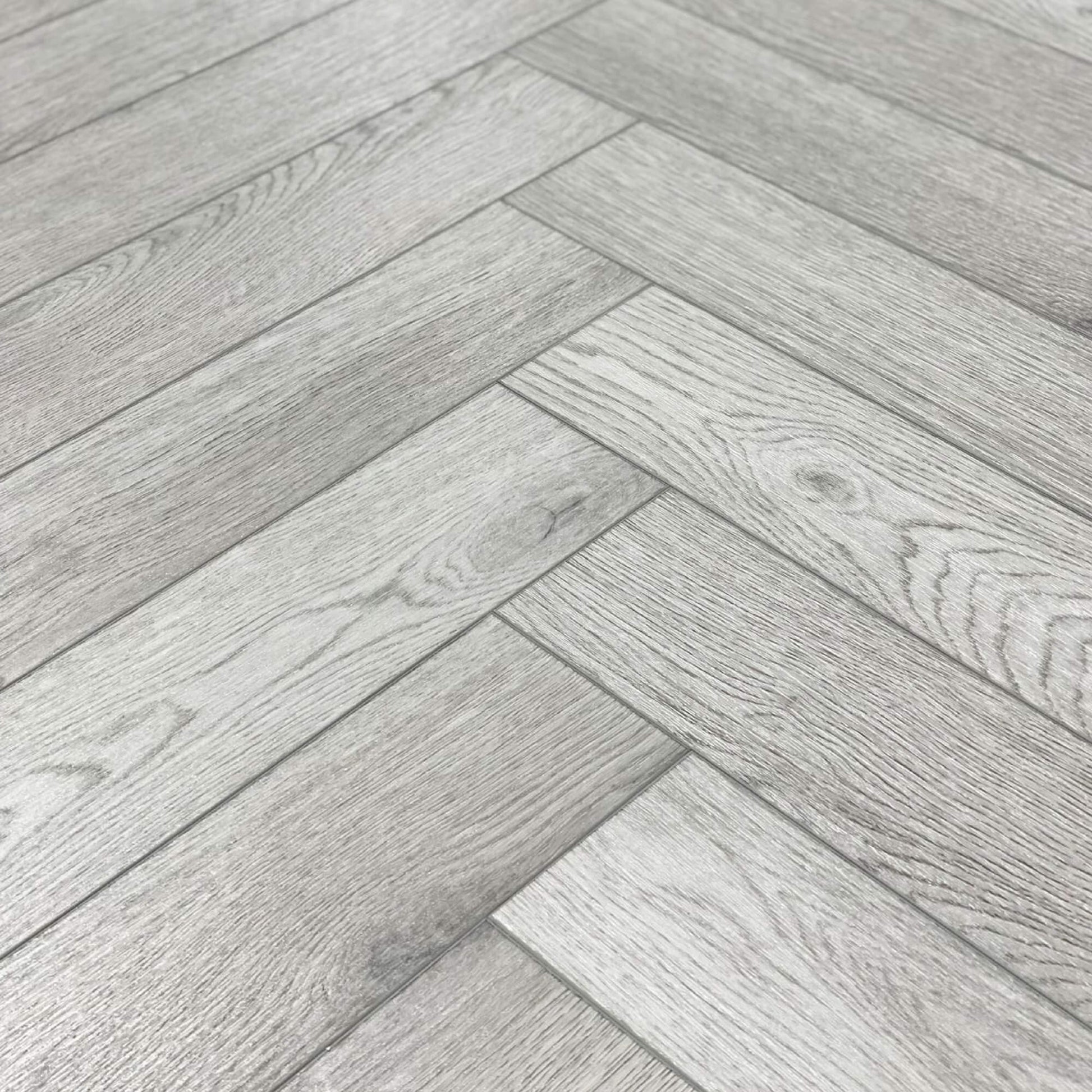 Close-up of Pyrenees Oak Rigid LVT Herringbone Flooring