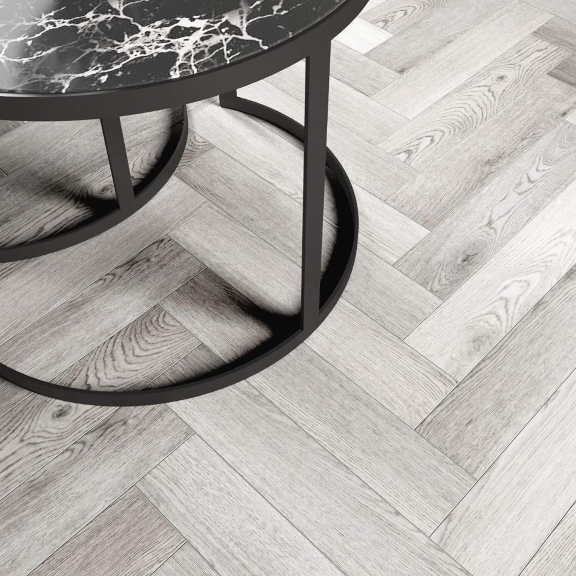 Pyrenees Oak Rigid LVT Herringbone Flooring with a table in the corner.