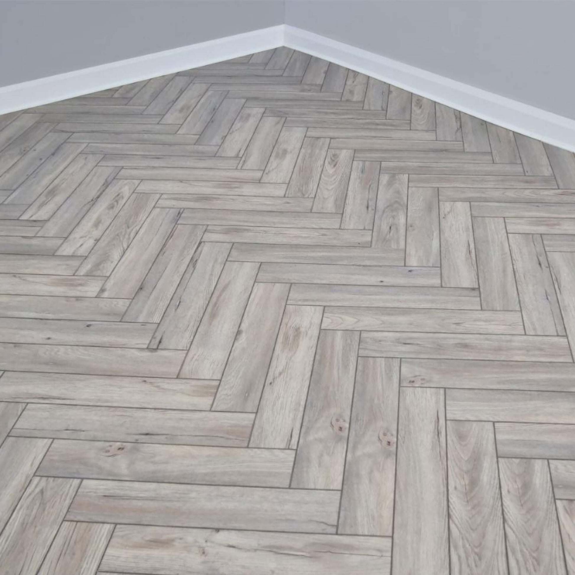 Wooden floor with Riviera Oak Rigid LVT Herringbone Flooring