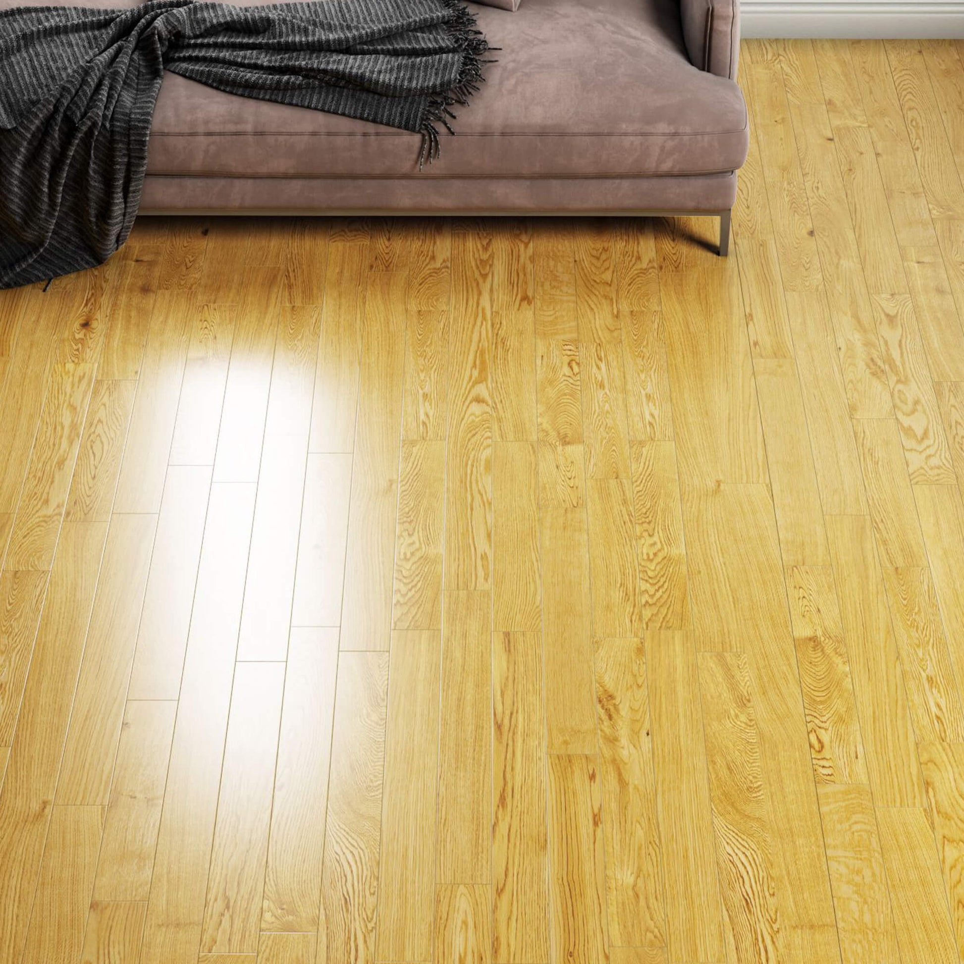 Rustic Oak 90mm lacquered engineered wooden floor with a sofa and blanket in the background.
