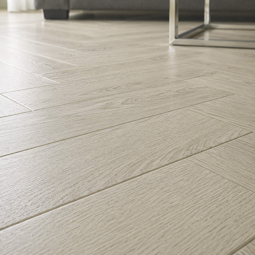 Close-up of Siberian Oak Rigid LVT herringbone flooring in a living room setting.