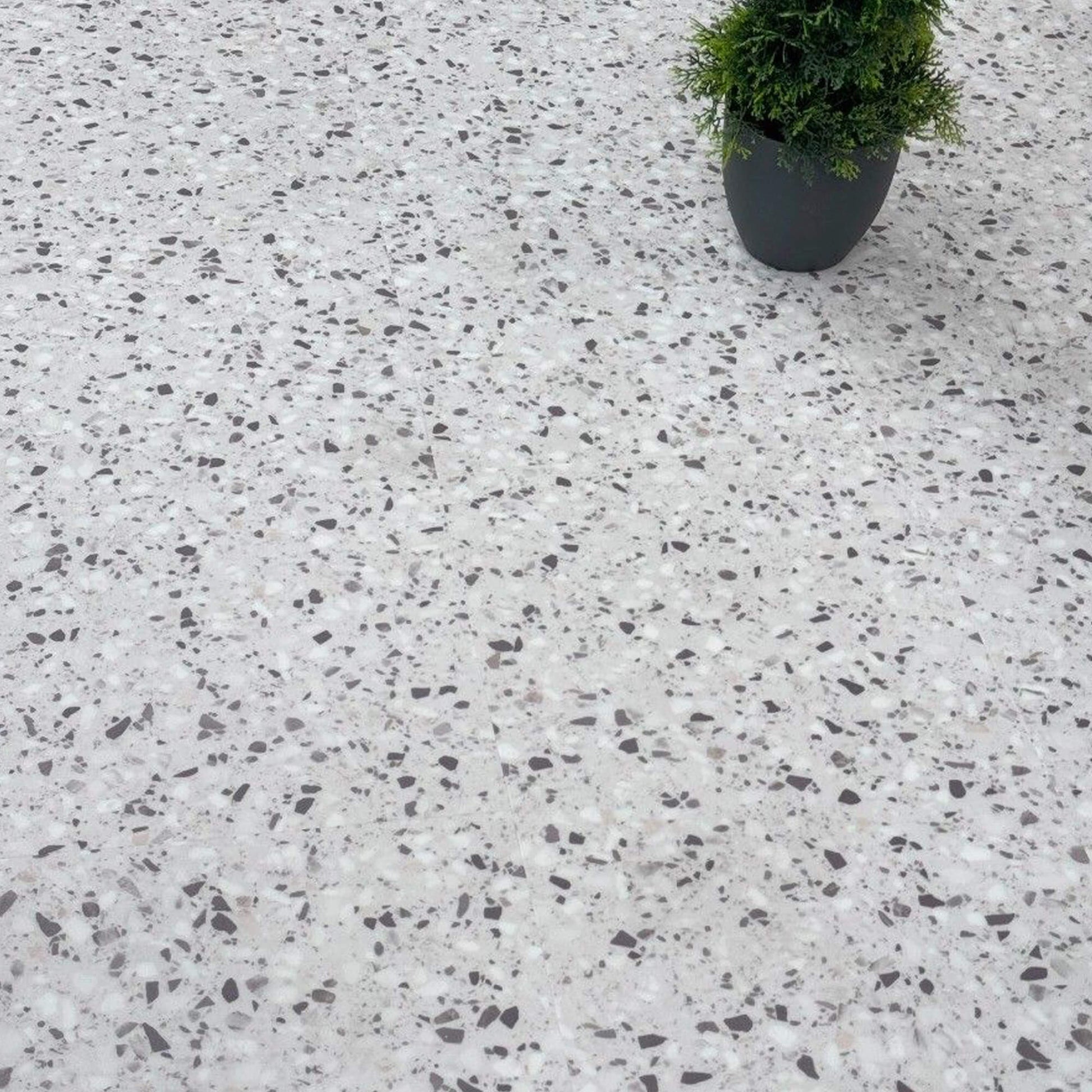 Verona Terrazzo Rigid LVT Floor Tile with a potted plant in the corner