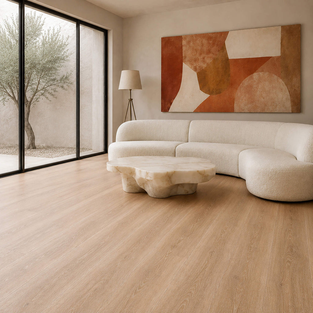 Modern living room with a white sofa, abstract painting, and Volcanic Larch Rigid LVT super plank flooring.