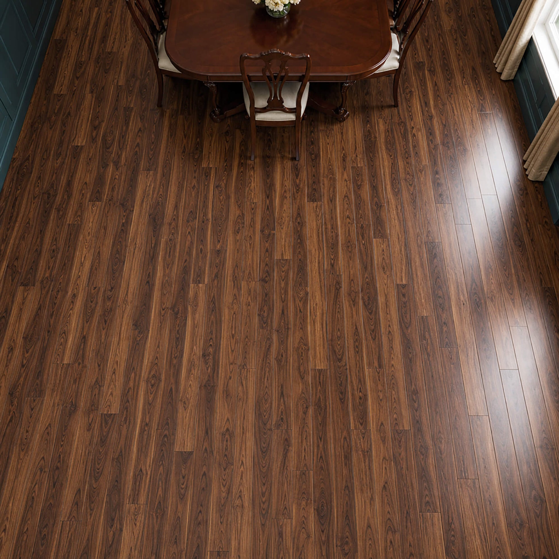 Elevated view of Walnut prestige laminate flooring in a dining room setting.